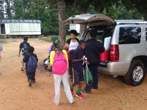 Members of Stillwater Church in Hammond pass out healthy snacks to kids getting off the bus at a local mobile home park. 
